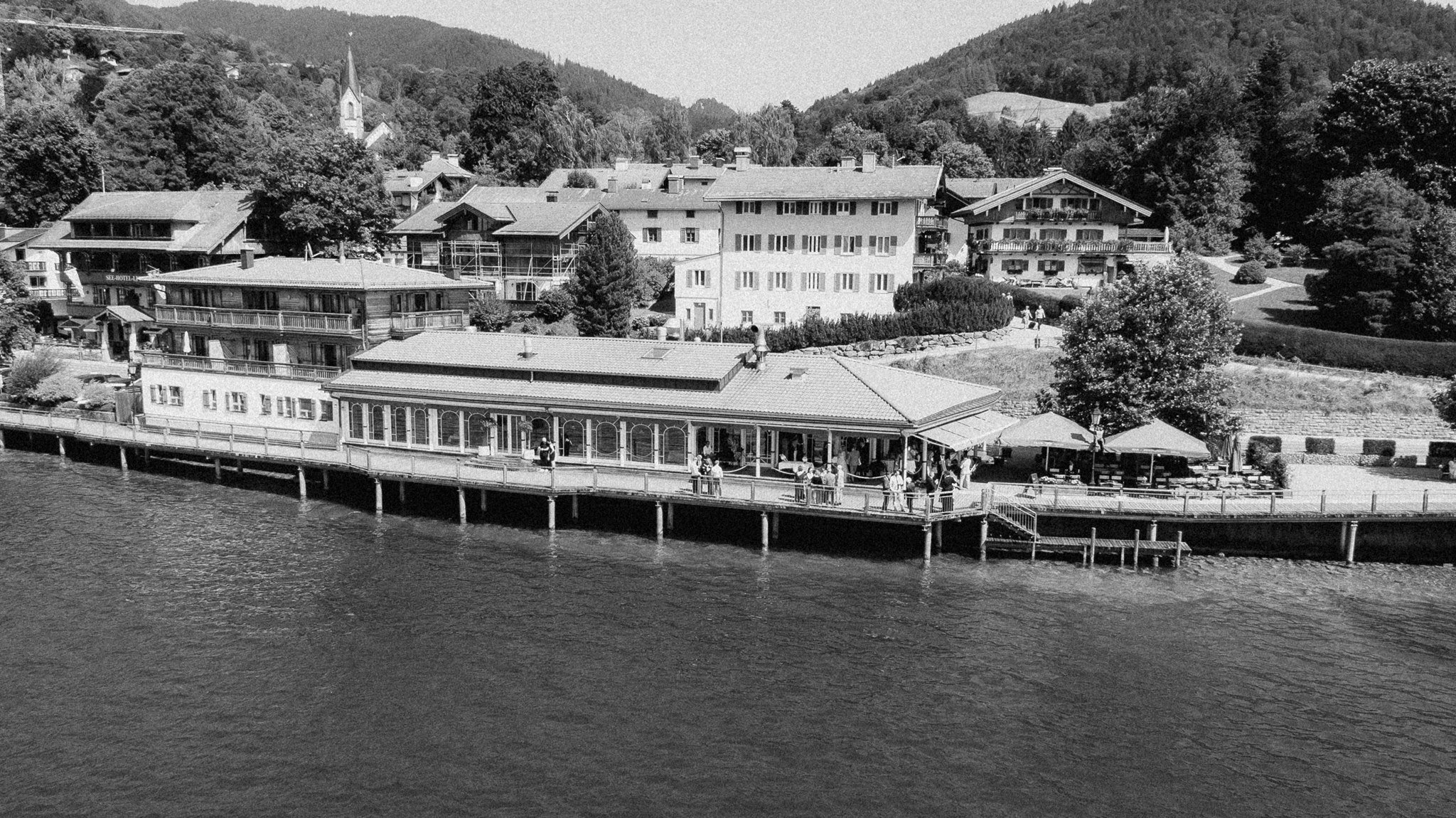 The Clubhaus at Lake Tegernsee seen from the water in black and white.