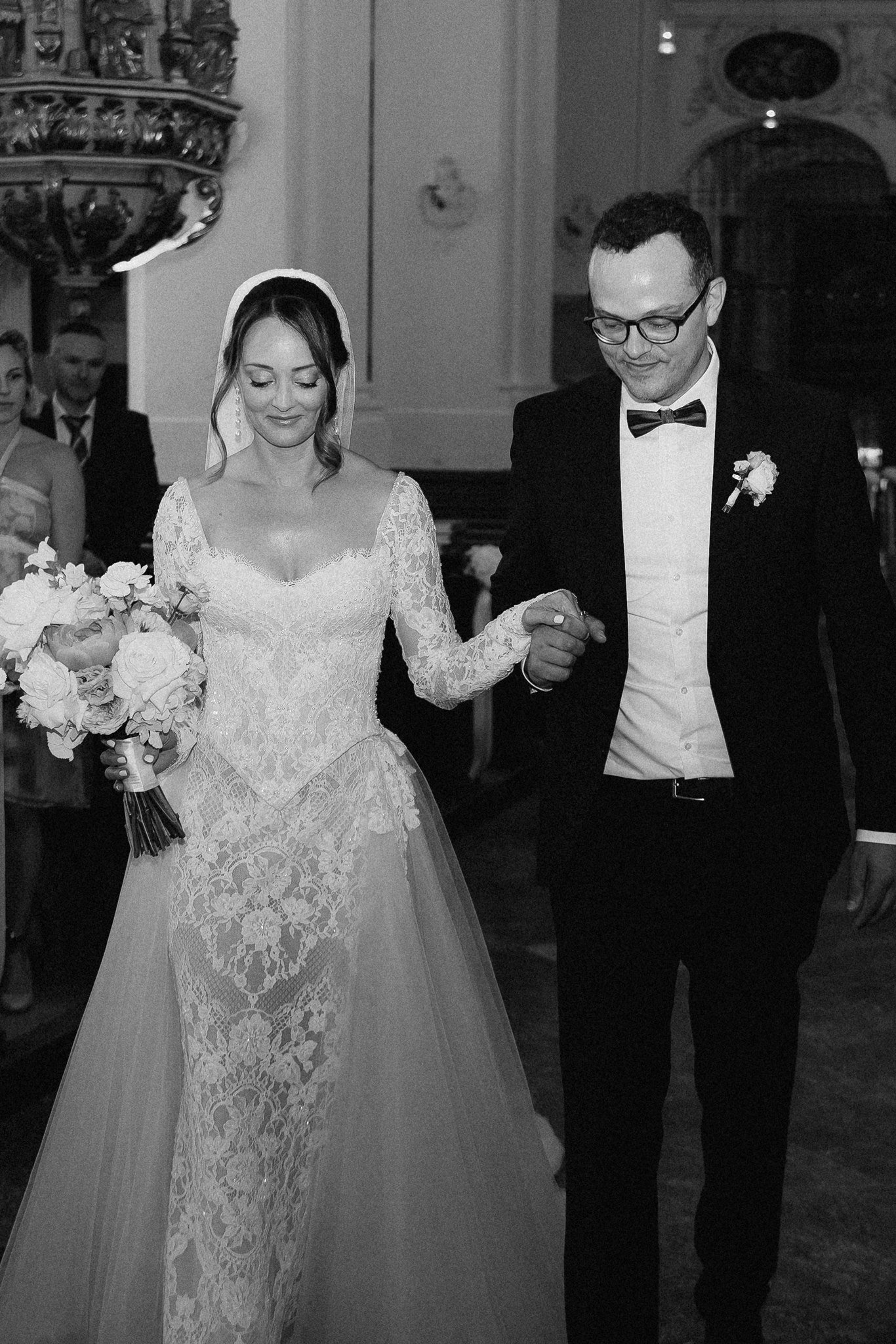 Sophia and Volker walk arm in arm after their church ceremony.