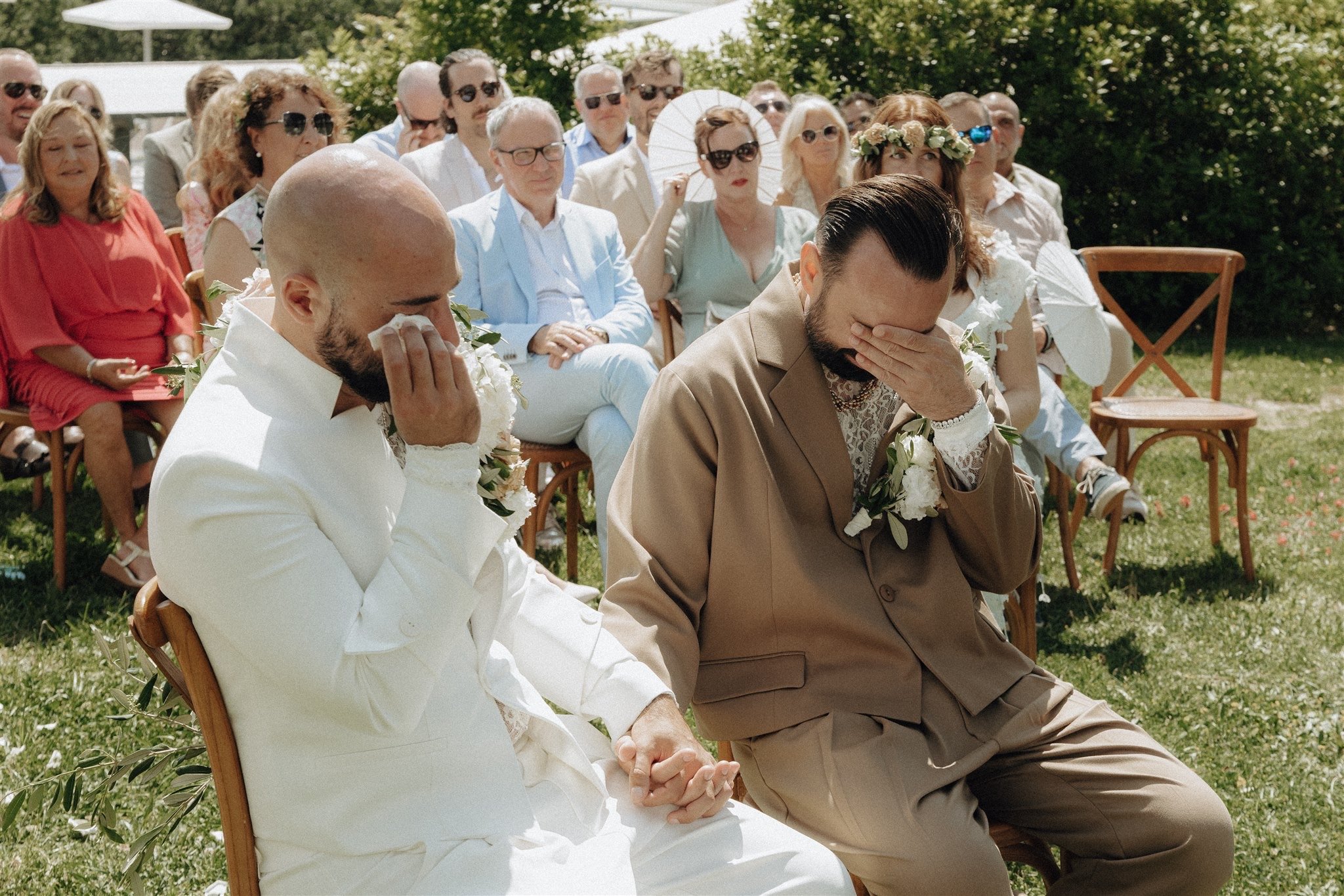 One groom wipes away a tear as Tony and Patryk exchange vows with their loved ones nearby.