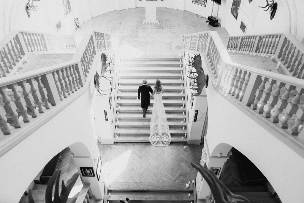 Petra and Dirk walk together on the grand staircase.