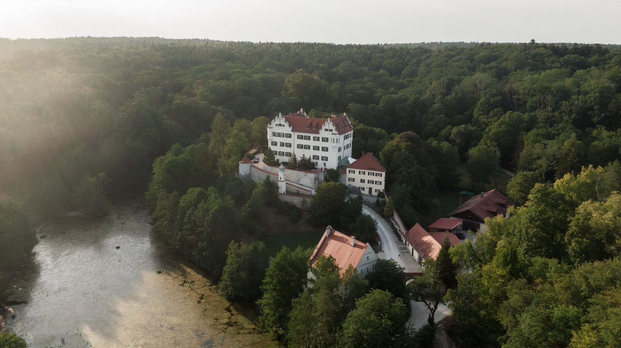 Aerial view of Schloss Duttenstein and the castle park at golden hour