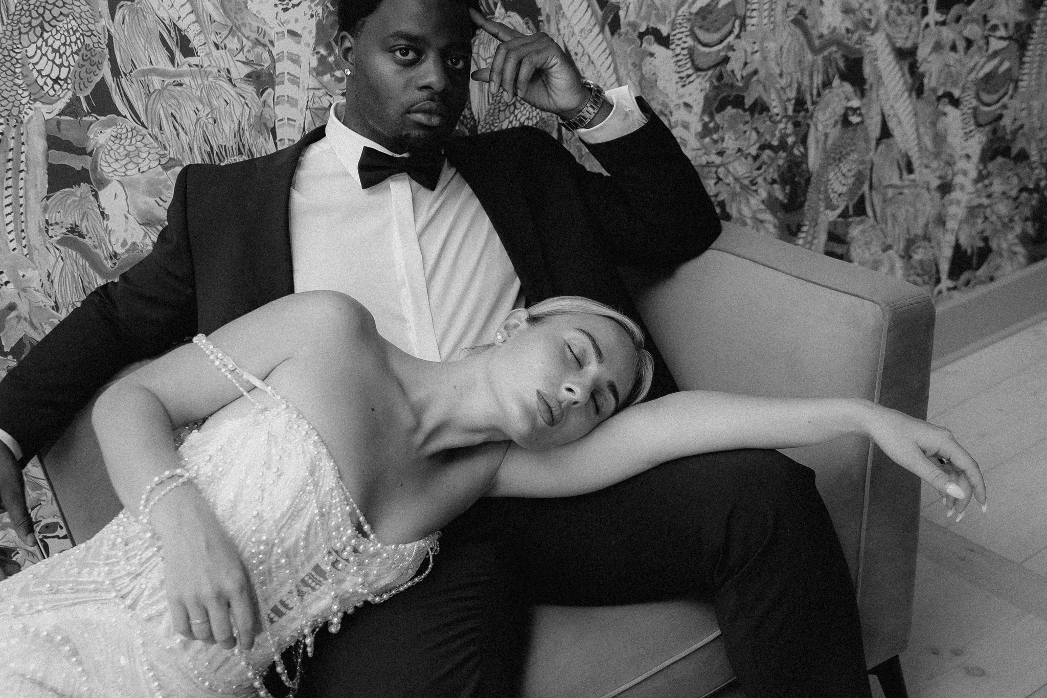 Bride in a pearl gown on the salon sofa, black and white editorial