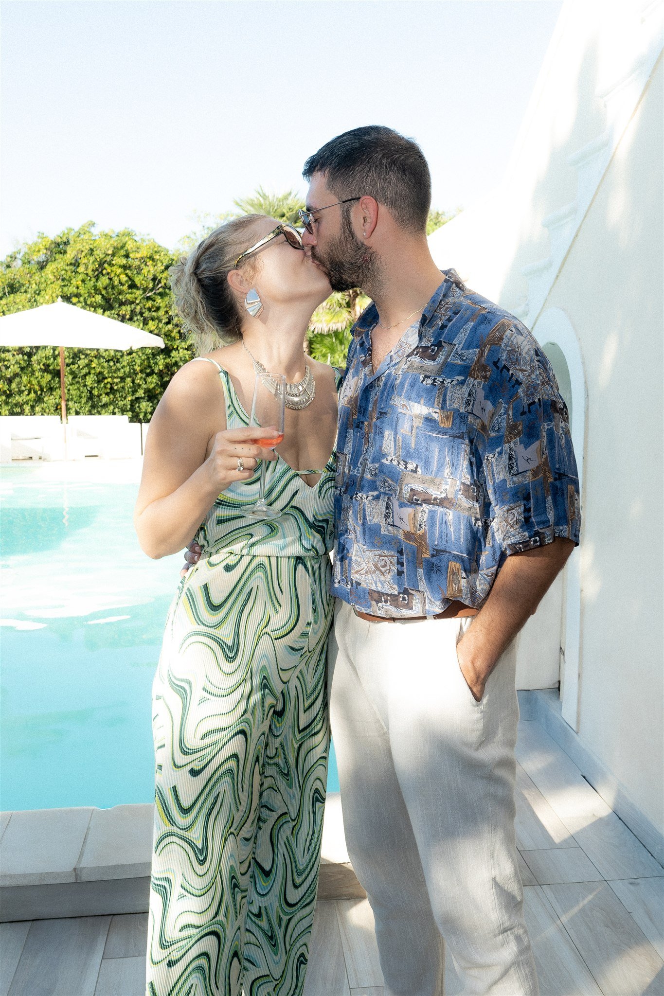 Guests sharing a kiss by the pool