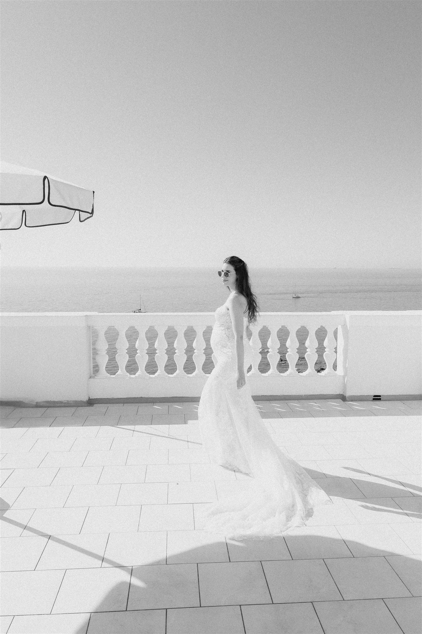 Bride on the sea-view terrace in black and white