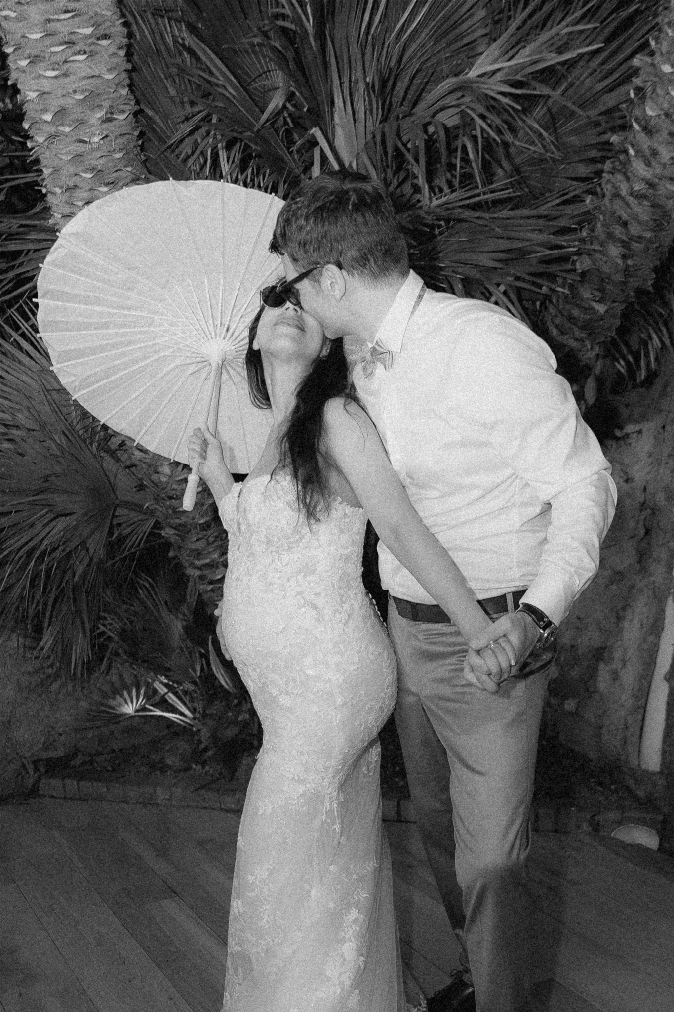 Dancing under the palms with a white parasol